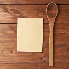 Wooden spoon next to recipe book