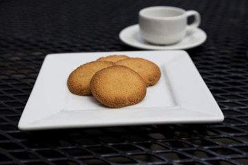 Butter cookies with espresso on patio table