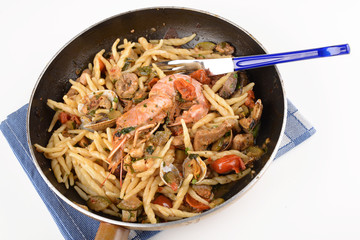 Trofie with costacei and fish in pan
