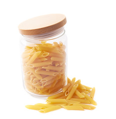 Glass jar filled with penne pasta isolated