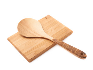 Wooden spoon over the cutting board isolated