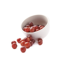Dark red grapes spilled out of bowl