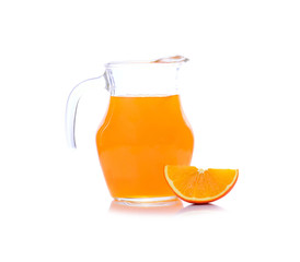 Orange juice in pitcher with orange. Isolated on white backgroun