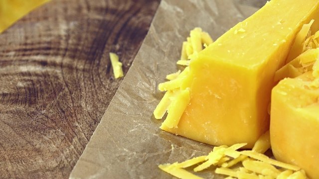 Rotating grated Cheddar (not loopable 4K UHD footage)