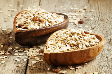 Homemade muesli in a bowl in the shape of a heart on a wooden ta