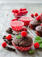 Brown chocolate muffins with raspberries