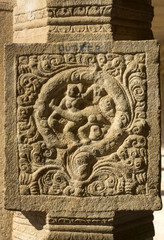 Mural sculpture of frolicking women.