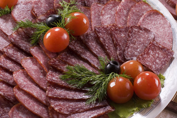 A composition of the meat, sausages and vegetables.