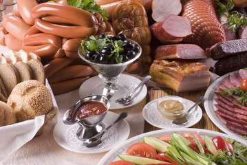 A composition of the meat, sausages and vegetables.