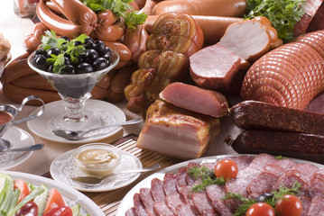 A composition of the meat, sausages and vegetables.