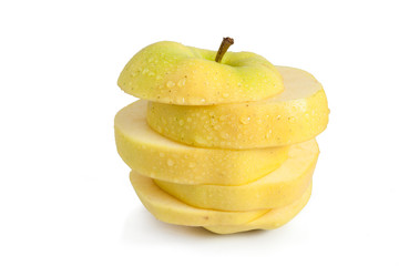 Single yellow apple cut into horizontal slices