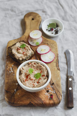chicken pate in a bowl and a sandwich with pate 