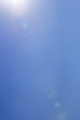 Light leak and lens flare from the sun on the clear sky
