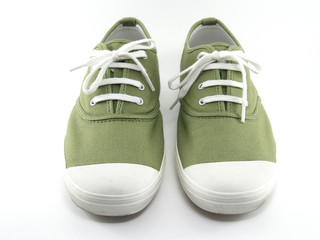 pair of green sneaker canvas shoes with tied string isolated on white