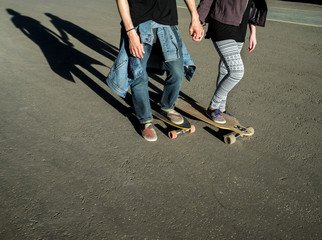 Couple on skateboard and longboard