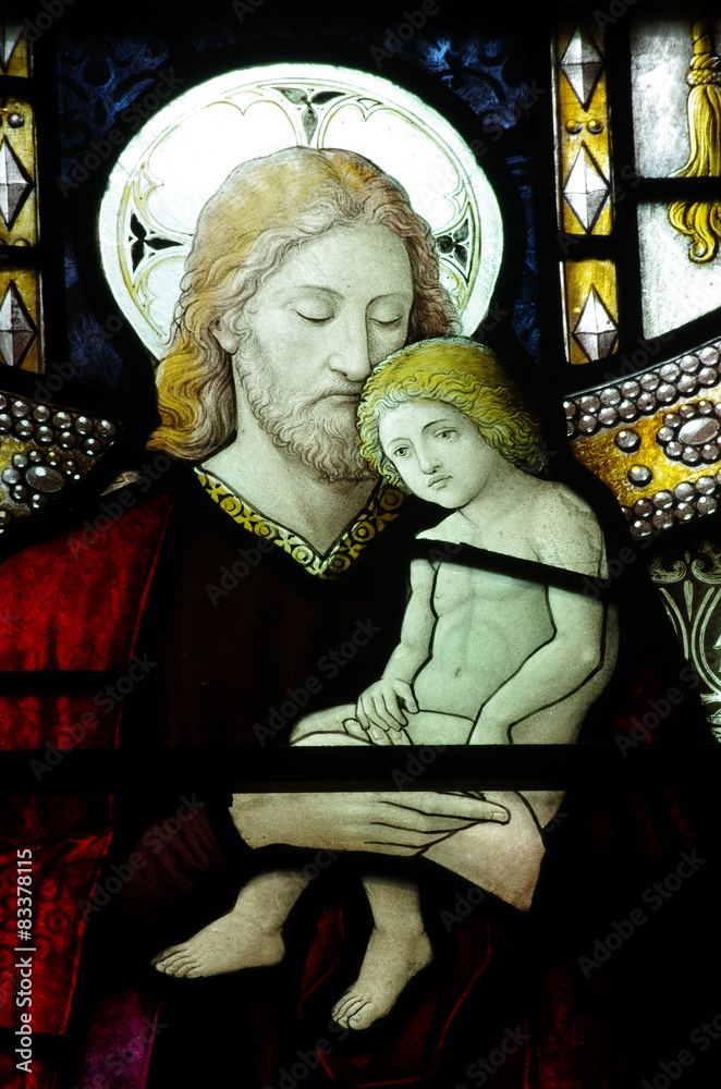 Wall mural jesus christ with a young child in his arms (in stained glass)