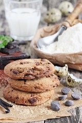 Chocolate cookies with chocolate chips on a rustic wooden table 