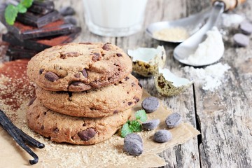 Chocolate cookies with chocolate chips on a rustic wooden table 