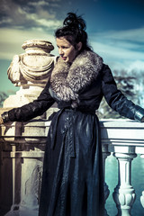 Russian woman in fur coat in a park in autumn