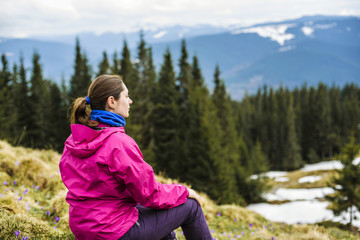 Fototapeta na wymiar young caucasian girl sitting outdoors in mountains
