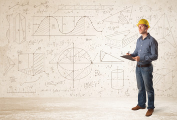 Handsome engineer calculating with hand drawn background