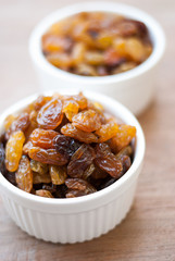 Heap of Raisins on vintage wooden background