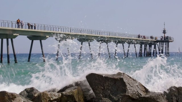 Footbridge over the sea with people walking  .Time Lapse