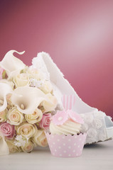 Wedding concept cupcakes and shoe on marsala background.
