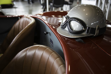 helmet and glasses on a luxury convertible sports car