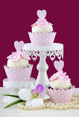 Wedding concept cupcakes on marsala background.