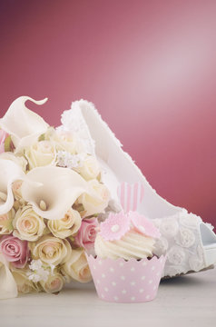 Wedding concept cupcakes and shoe on marsala background.