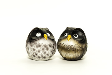 Couple resin owls stand close to each other