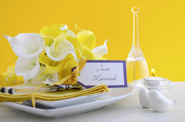Yellow and white theme wedding table place setting.