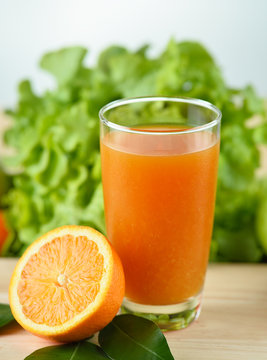 Orange juice in glass  on wooden background