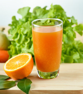 Orange juice in glass  on wooden background