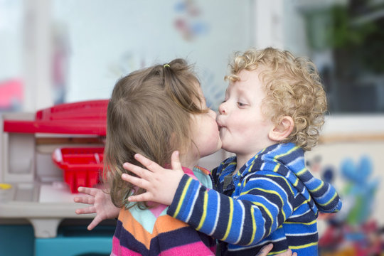 Little boy kiss a little girl