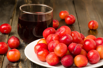 Fresh plum (Julee) and juice on wooden background,healthy food