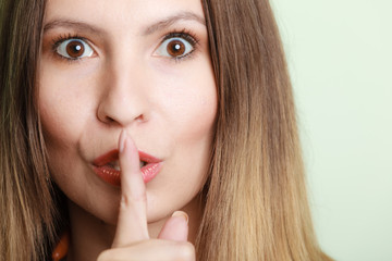 Naklejka premium Woman asking for silence finger on lips hush hand gesture.