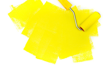 yellow paint roller on white background