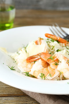 Delicious risotto with shrimp and dill on white plate