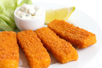 Golden fried fish fingers with lemon and tartar sauce.