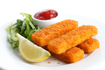 Golden fried fish fingers with lemon and tomato sauce.