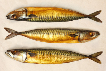 Whole smoked mackerels on brown paper. From above.