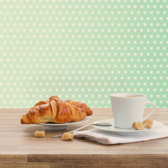 cup of coffee with croissant