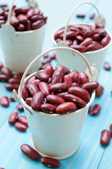 Kidney beans in white bucket on wooden board, healthy food