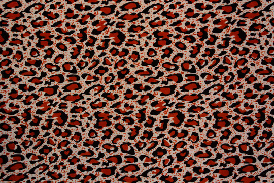 Red and black leopard pattern. Spotted fur animal print as backg