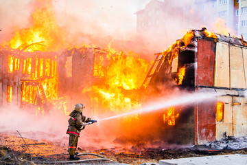 Naklejka premium Fireman extinguishes a fire