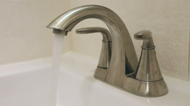 Opening, running, and closing bathroom faucet