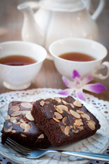 Sweet beownie and cup of tea on wooden table