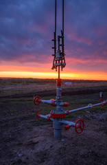 Oil pumping station at sunset